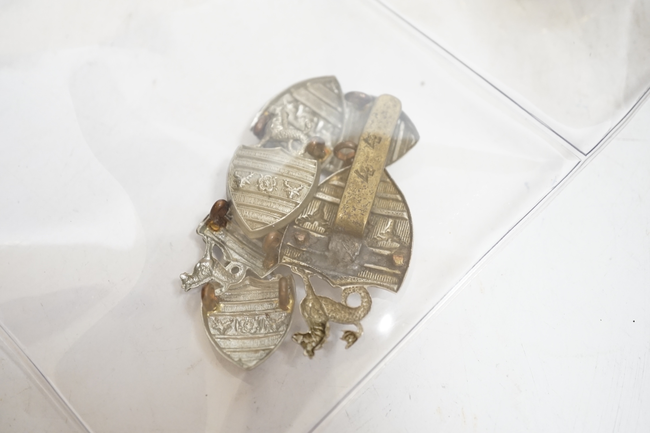 A collection of Police badges and buttons, including to Eastbourne Borough Police helmet plates, Eastbourne Fire Brigade uniform buttons, Royal Navy buttons, a whistle, etc. together with a batten decorated with beadwork